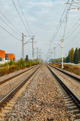 Two lane railroad with electric power lines