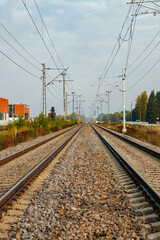 Obraz premium Two lane railroad with electric power lines