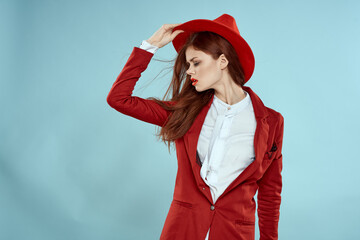 Beautiful woman in red hat jacket red lips long hair charm blue background