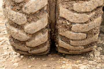 close up of the tire profile of an excavator, a lot of dirt in the profile