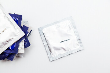 Condom packs on a white background. Safe sex and protection, contraception, protection against AIDS and AIDS day.