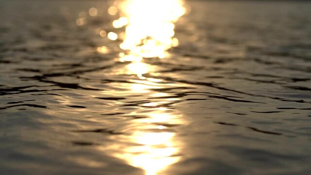 Reflection of sunlight over lake surface in slow motion
