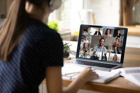 Close Up Rear View Of Female Student Study Distant At Home On Computer, Engaged In Group Webcam Lecture Or Lesson. Woman Speak Talk On Video Call With Diverse Colleagues, Have Online Team Meeting.