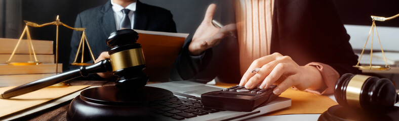 justice and law concept.Male judge in a courtroom on wooden table and Counselor or Male lawyer working in office. Legal law, advice and justice concept.