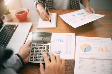 Investment concept, Investor calculating a valuation of stock market exchange, Selected focus.