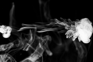 Clouds of white smoke on a black background, movement of smoke, smoke in the shape of a jellyfish