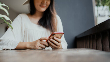 Female traveler relaxing using mobile phone searching for a tour trip.