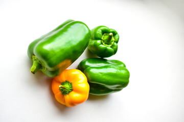 Yellow green regular pepper on a white background