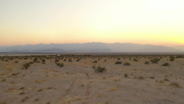 Low drone shot, wide view from the desert at mexicali valley, entering the salt lake from Baja California Mexico