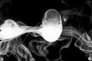 Clouds of white smoke on a black background, movement of smoke, smoke in the shape of a jellyfish