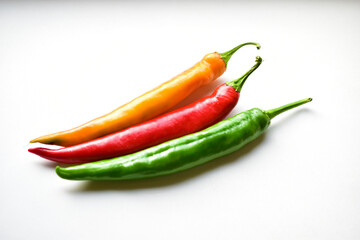 Yellow red and green capsicum on a white background
