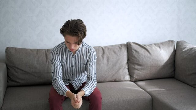 young teenager is suffering. guy is crying. Adolescent problems. Awkward age.