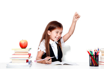 Happy and cute teen schoolgirl raising hand in classroom