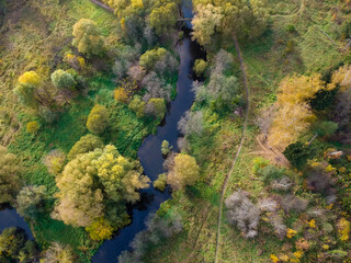 Aerial drone view of autumn forest and small river