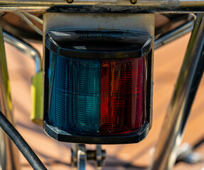 Close up of a navigational lantern showing starboard and port side, mounted on the bow of a...