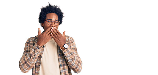 Handsome african american man with afro hair wearing casual clothes and glasses laughing and...