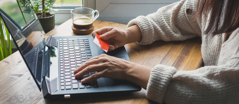 Shopping online, woman's hands makes purchases in the online store online in lockdown coronavirus quarantine, discounts on black friday, cyber monday.