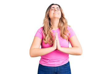 Young caucasian woman wearing sportswear begging and praying with hands together with hope expression on face very emotional and worried. begging.