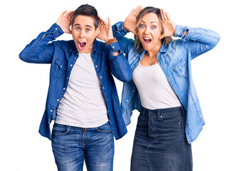Obraz premium Couple of women wearing casual clothes smiling cheerful playing peek a boo with hands showing face. surprised and exited