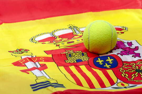 TENNIS OR PADEL BALL ON THE SPANISH FLAG. CARLOS ALCARAZ AND RAFAEL NADAL SUCCESS.