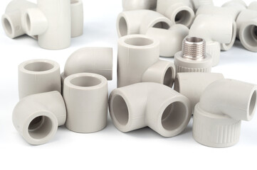 Various fittings for soldering and connecting polypropylene pipes on a white background