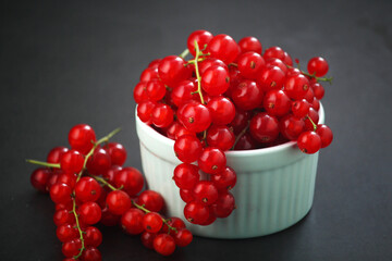 A ceramic bowl with red currant berries
