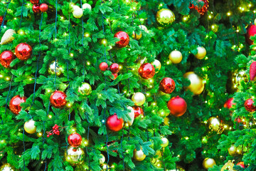 Obraz na płótnie Canvas New Year greeting concept. Christmas green background. Christmas trees decorated with red and golden decorations and lights, garlands and toys. Illumination