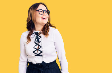 Young beautiful caucasian woman wearing business shirt and glasses looking away to side with smile on face, natural expression. laughing confident.
