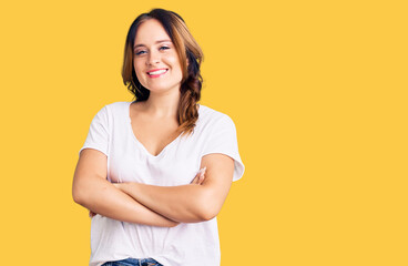 Young beautiful caucasian woman wearing casual white tshirt happy face smiling with crossed arms looking at the camera. positive person.