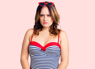 Young beautiful caucasian woman wearing swimwear skeptic and nervous, frowning upset because of problem. negative person.