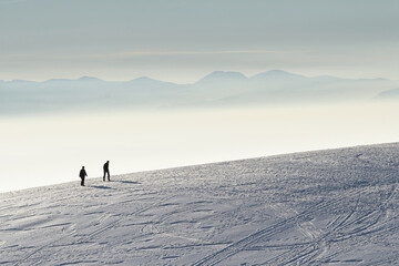 Men trekking in the mountains with snow