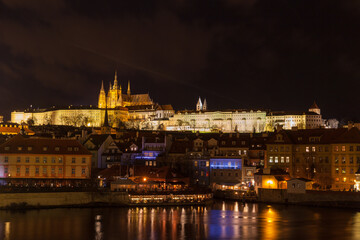 Fototapeta na wymiar Beautiful night view of the light illuminated Prague Castle and St. Vitus Cathedral in Mala Strana old town by Vltava River from Charles Bridge, Prague, Czech Republic