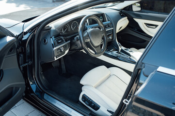 Car inside driver place. Interior of prestige modern car. Front seats with steering wheel