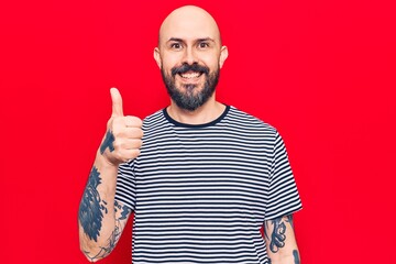 Fototapeta premium Young handsome man wearing casual clothes smiling happy and positive, thumb up doing excellent and approval sign