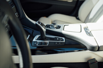 Fototapeta na wymiar gear knob in a luxury car with beige leather