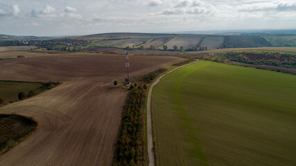 Fototapeta na wymiar Aerial view of Czech landscape and transmitter between fields and meadows.