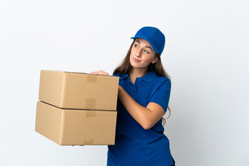 Young delivery woman over isolated white background looking up while smiling