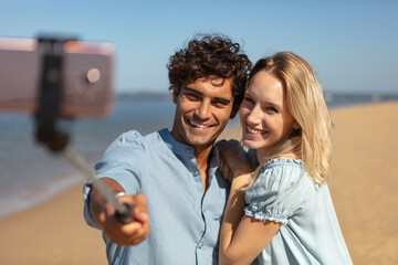 couple taking a selfie on the beach