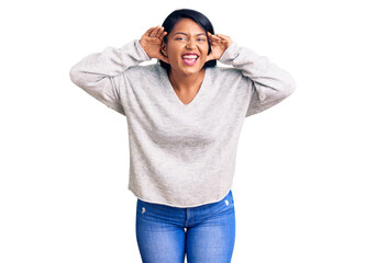 Naklejka premium Hispanic woman with long hair wearing casual clothes trying to hear both hands on ear gesture, curious for gossip. hearing problem, deaf