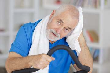an attractive senior man at health club exercising on stepper