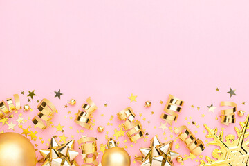 Christmas pink flatly. Many sparkling golden confetti, decorative snowflake and ribbons at pink background. Festive concept.