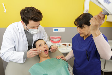 male dentist treating female patient