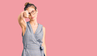 Beautiful caucasian woman with blonde hair wearing business clothes and glasses looking unhappy and angry showing rejection and negative with thumbs down gesture. bad expression.