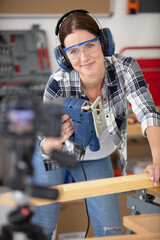 young female repairman recording video for her blog