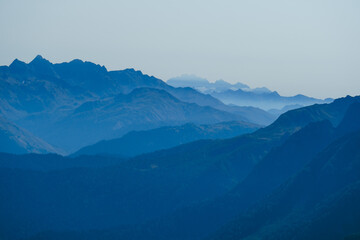 Obraz premium blurred abstract natural background with Caucasus Mountains in a morning blue mist