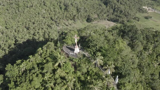 Leyte, Philippines - Gorgeous View Of A Religious Cross Christ the Redeemer At The Top Of The Mountain Surrounded By Green Trees - Aerial Drone Shot
