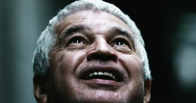 Middle aged old man face looks up with gratitude