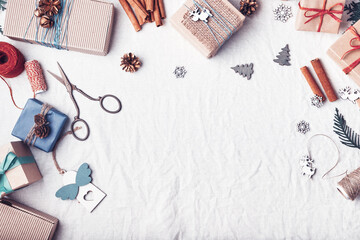 Christmas gifts on white crumpled fabric. Ecological packaging. Zero waste holidays.