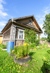 Decorative flowers in front of the old wooden house