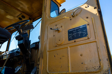 Closeup of a yellow tractor, russian instructions
